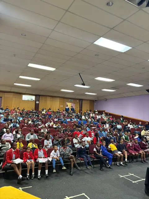 Learners and guests filling the auditorium for the spelling bee