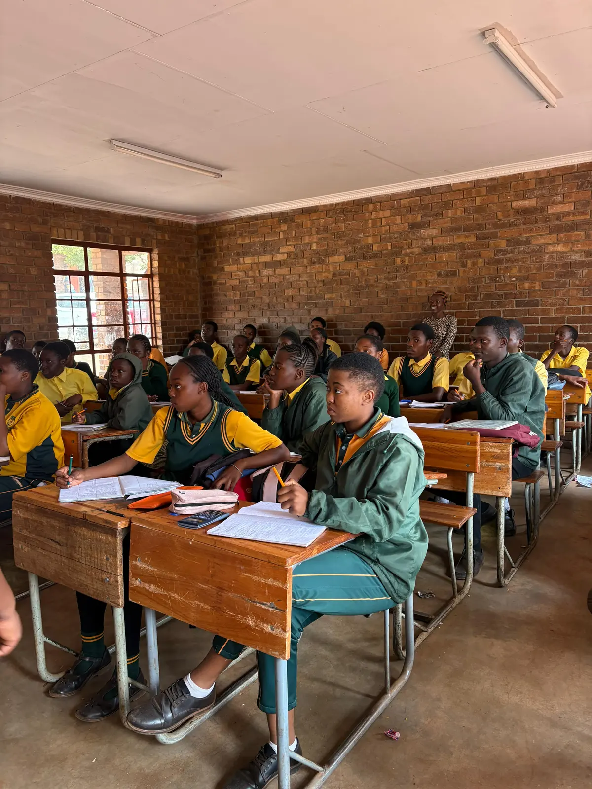 Learners working at their desks during a TruCam academic session